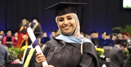 Graduate holding diploma